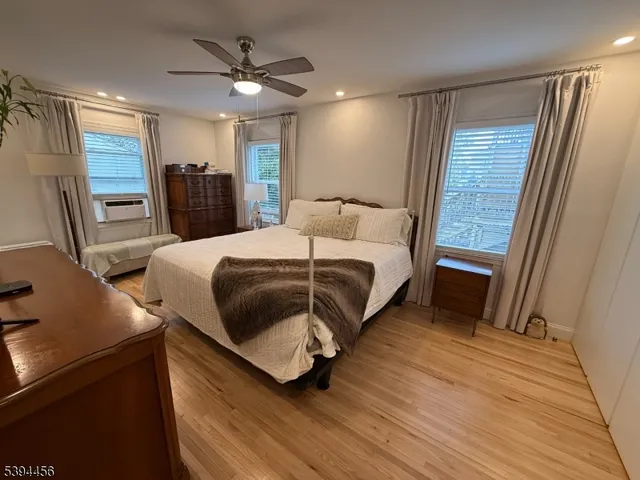 a bedroom with a bed and a ceiling fan