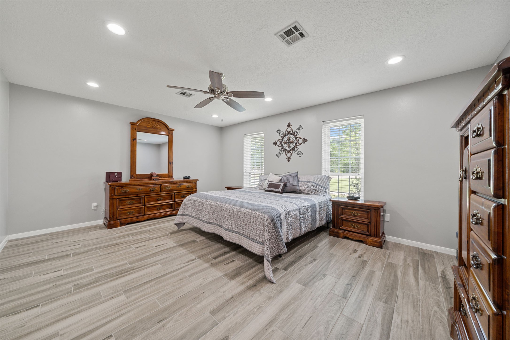 18823 Cypress Church Road Cypress, TX 77433 - Photo 29 of 44 a bedroom with a bed and a chandelier