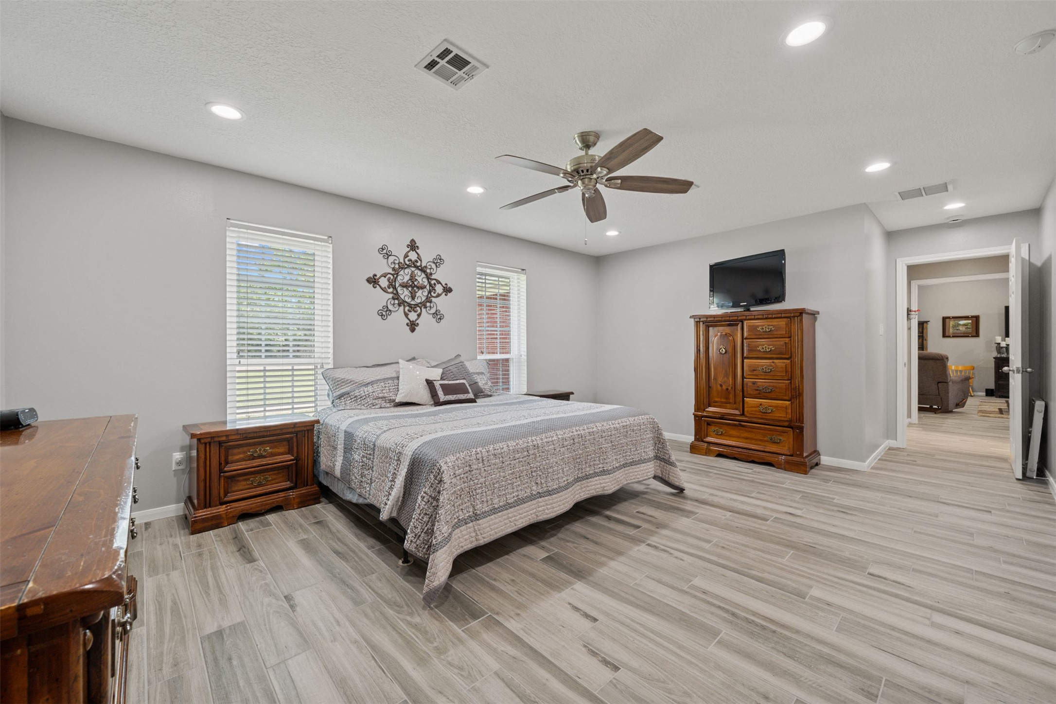 18823 Cypress Church Road Cypress, TX 77433 - Photo 31 of 44 a bedroom with a bed and a chandelier