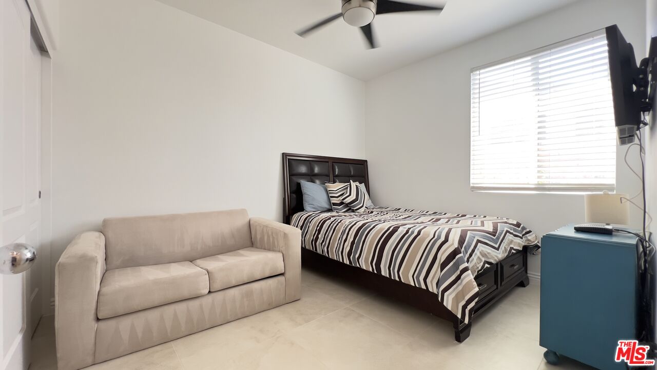 84330 Tramonto Way Indio, CA 92203 - Photo 9 of 18 a bedroom with a bed couch and window