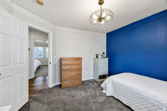 892 East 400 South Smithfield, UT 84335 - Photo 26 of 44 Bedroom featuring dark colored carpet and suspended lighting