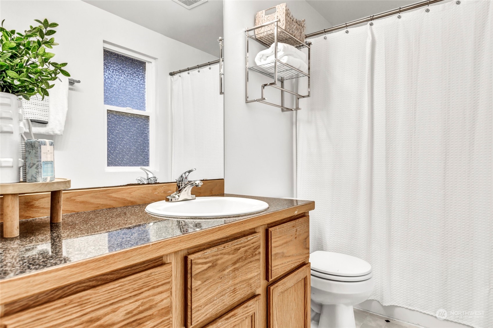 8317 233rd Street Southwest, Unit 3 Edmonds, WA 98026 - Photo 15 of 31 a bathroom with a sink a toilet and shower