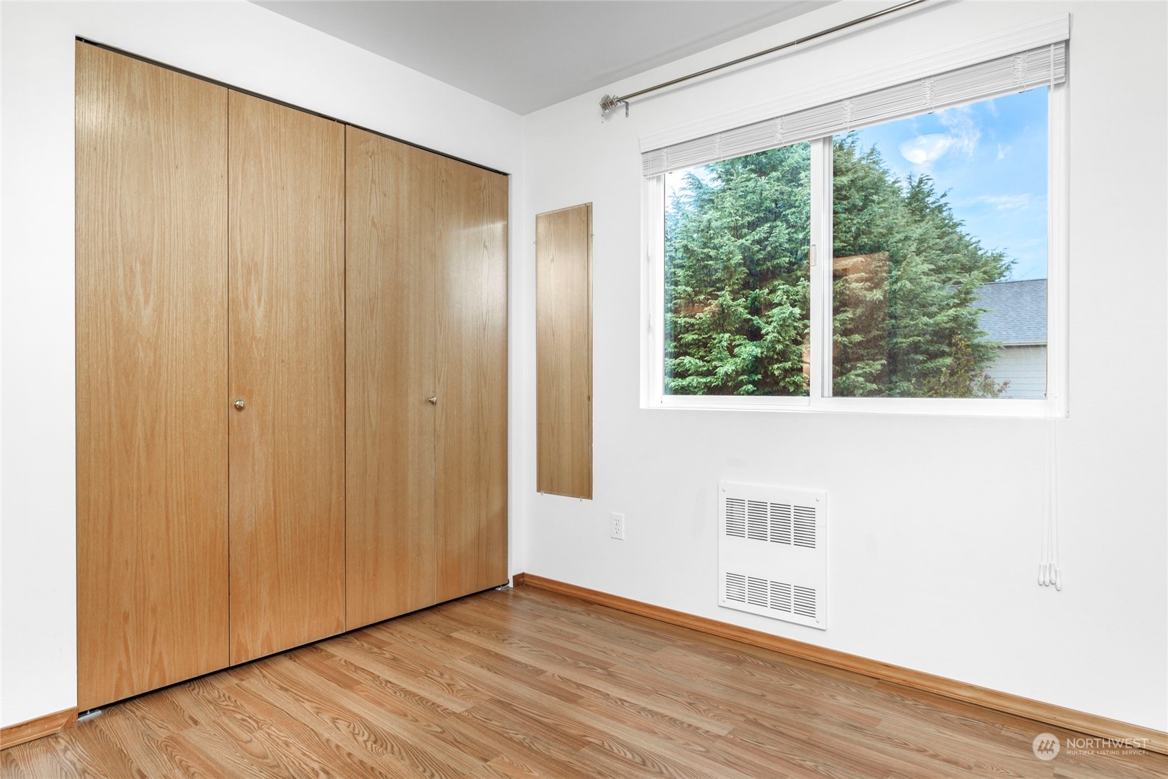 8317 233rd Street Southwest, Unit 3 Edmonds, WA 98026 - Photo 18 of 31 a view of an empty room with wooden floor and a window