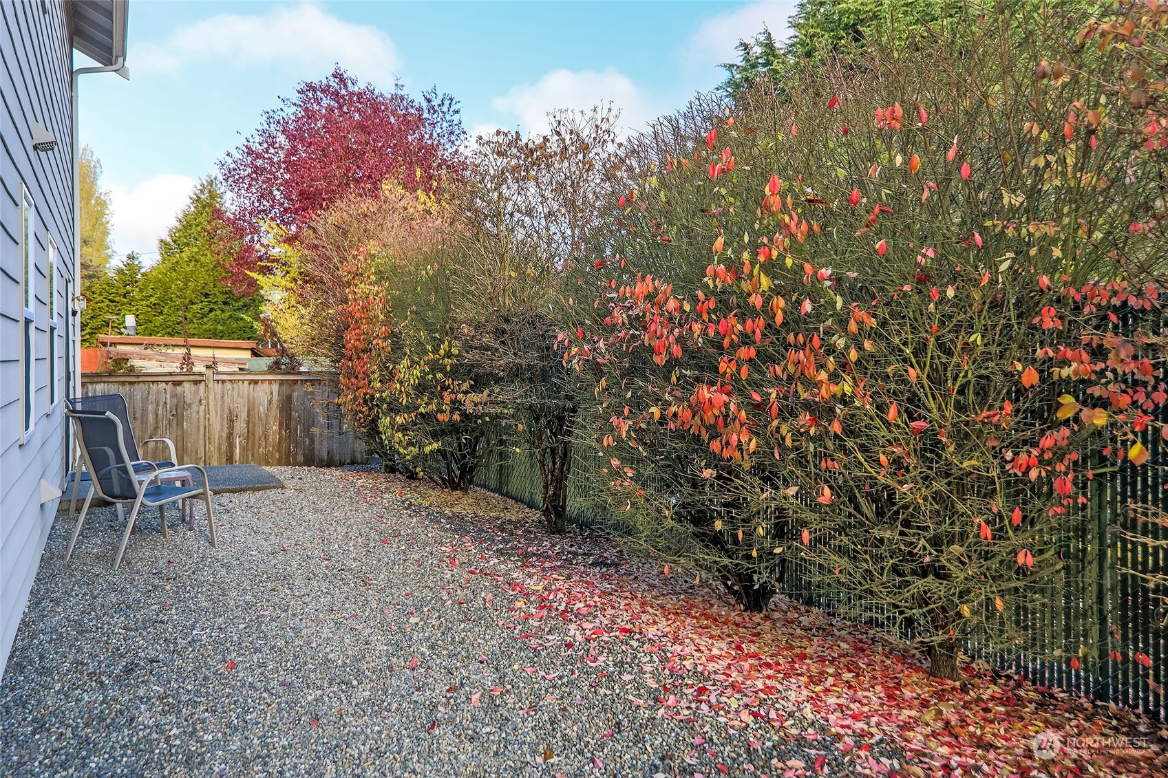 8317 233rd Street Southwest, Unit 3 Edmonds, WA 98026 - Photo 29 of 31 a backyard of a house with table and chairs