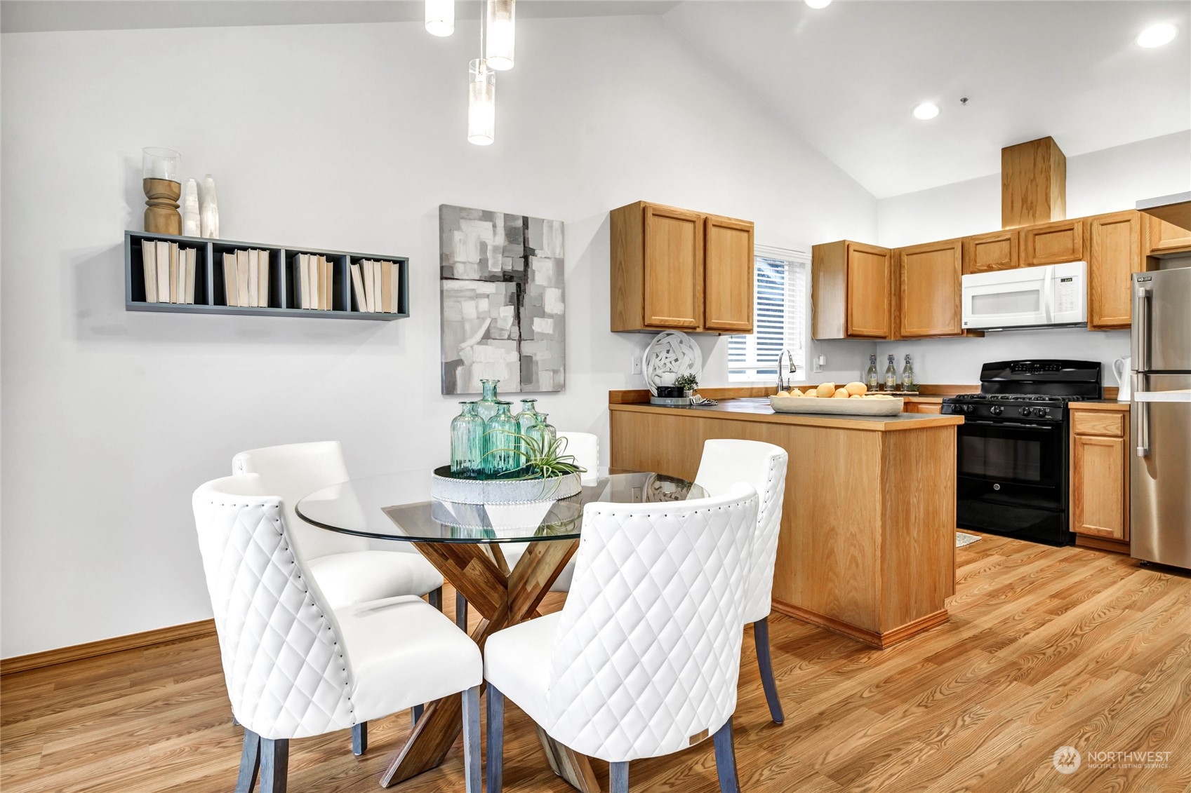 8317 233rd Street Southwest, Unit 3 Edmonds, WA 98026 - Photo 9 of 31 a kitchen with stainless steel appliances kitchen island granite countertop a kitchen island a stove a table and chairs