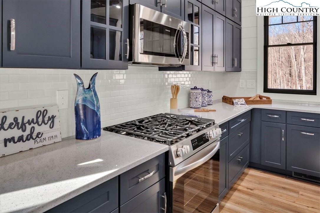 1518 Moxley Ridge Road Independence, VA 24348 - Photo 12 of 50 a kitchen with stainless steel appliances granite countertop a stove a sink and a microwave