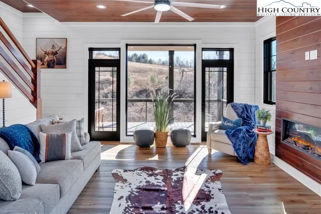 a bedroom with a bed a window and potted plant