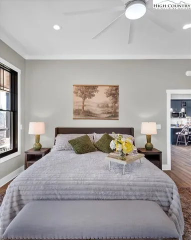 a bedroom with a bed and a large window