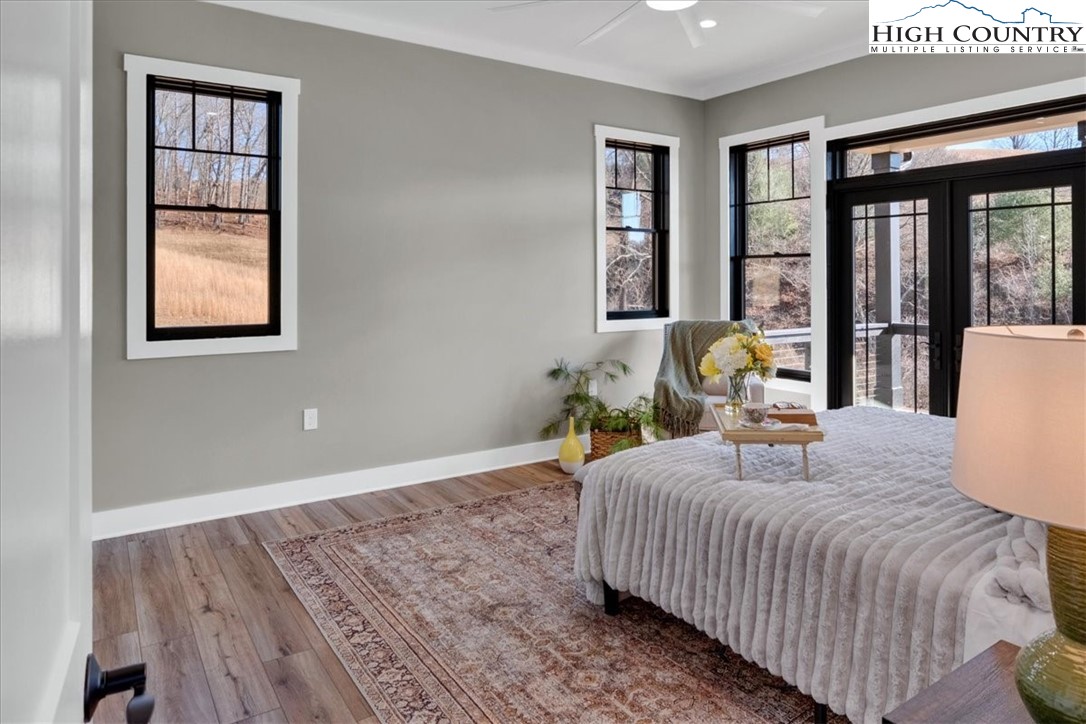 1518 Moxley Ridge Road Independence, VA 24348 - Photo 21 of 50 a bedroom with a bed a window and potted plant