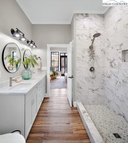 a bathroom with a granite countertop toilet a sink and mirror
