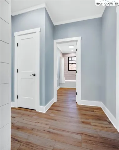 a view of a hallway with wooden floor