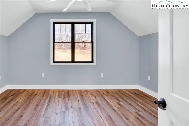 a bathroom with a toilet a sink a mirror a bathtub and vanity