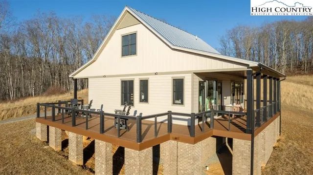 a front view of a house with a yard outdoor seating and mountain view