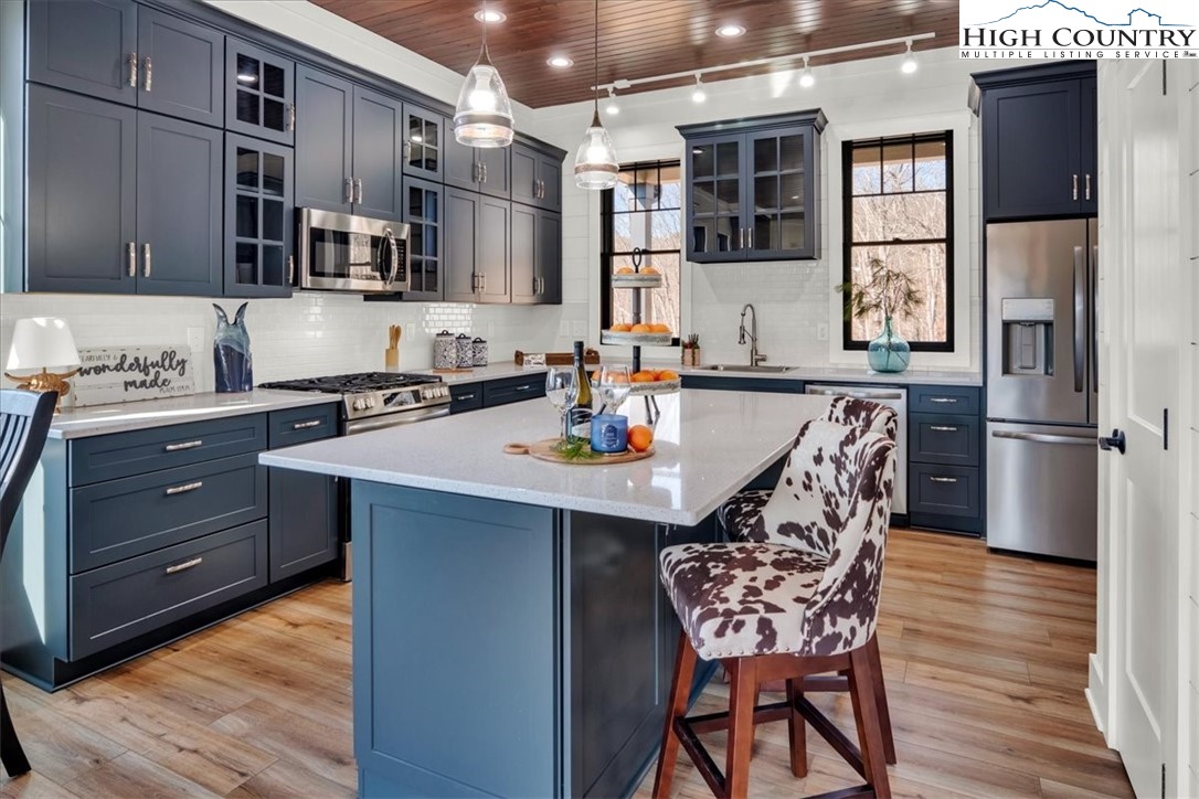 1518 Moxley Ridge Road Independence, VA 24348 - Photo 10 of 50 a kitchen with stainless steel appliances granite countertop a sink dishwasher a refrigerator and wooden floor