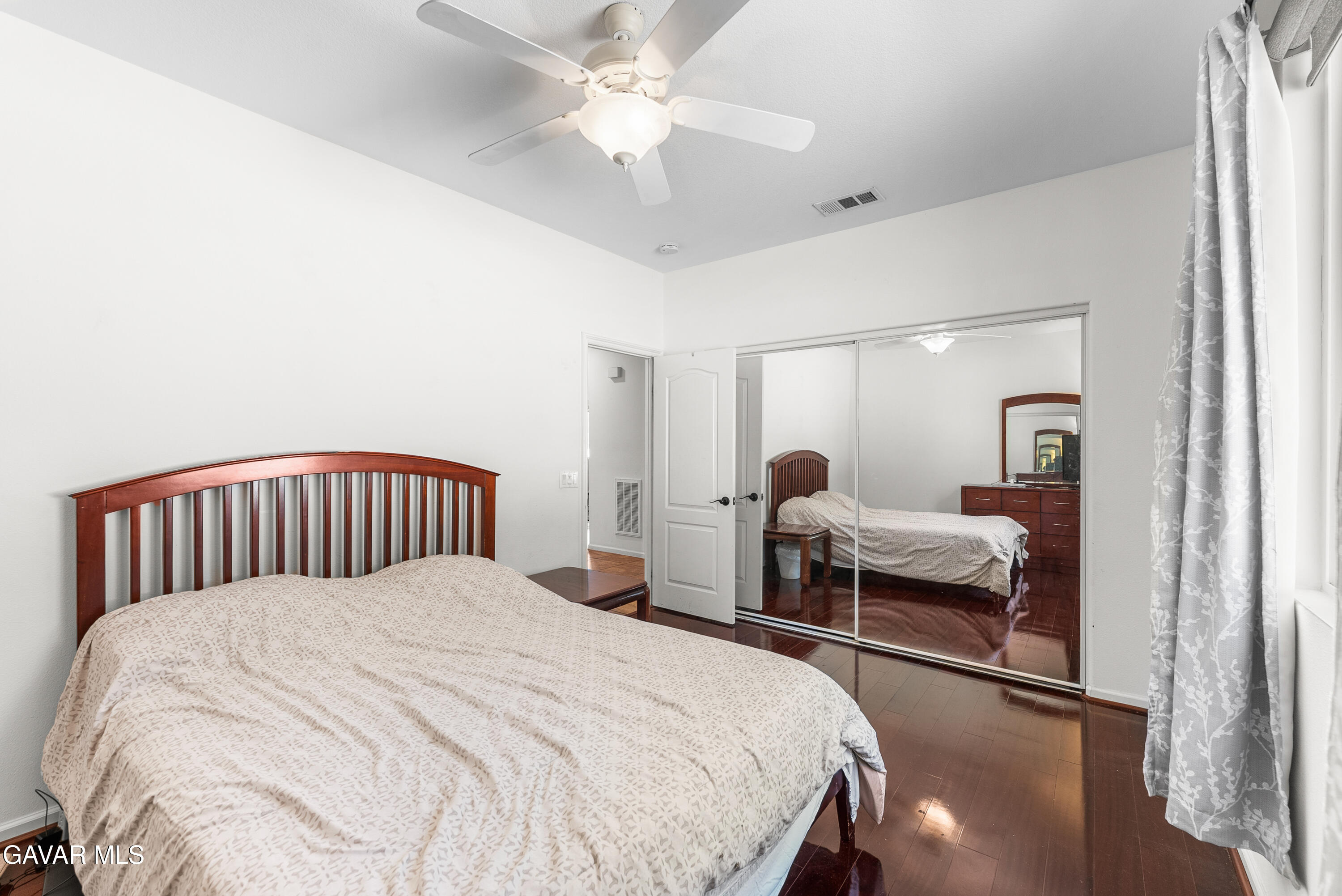 658 Lago Lindo Road Palmdale, CA 93550 - Photo 37 of 91 a bedroom with a bed and a chandelier