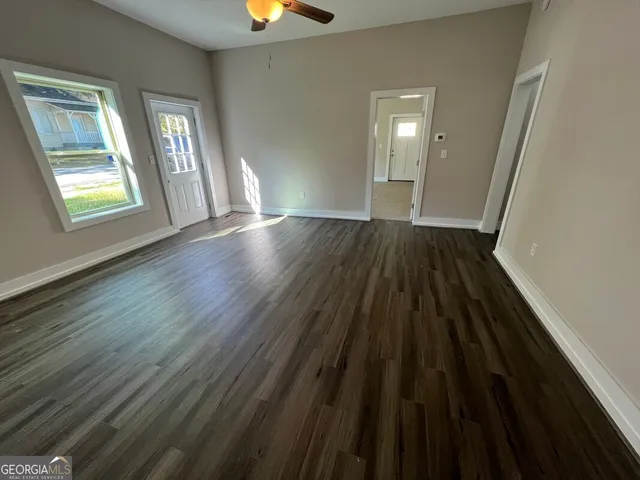 wooden floor in an empty room with a window