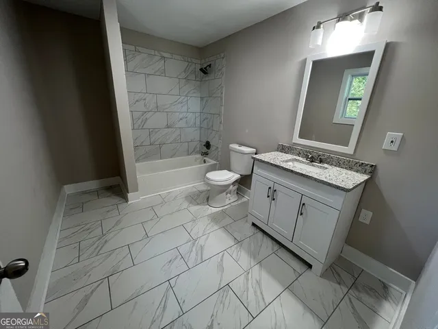 a white bath tub and shower in a bathroom