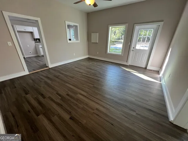 wooden floor in an empty room with a window