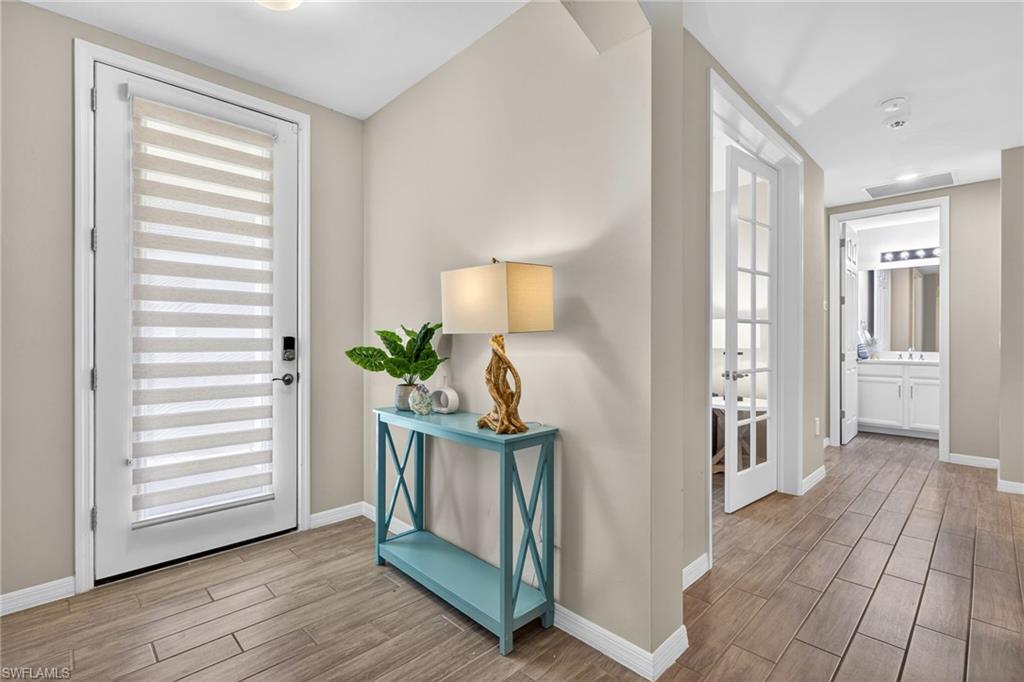 14567 Edgewater Circle Naples, FL 34114 - Photo 2 of 43 a view of entryway with wooden floor