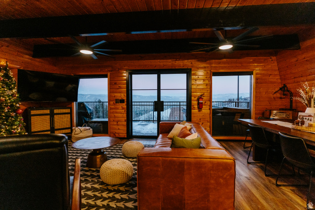 1413 Basel Drive Midway, UT 84049 - Photo 17 of 137 Living area featuring a ceiling fan, wood walls, dark wood finished floors, and a wood ceiling with exposed beams