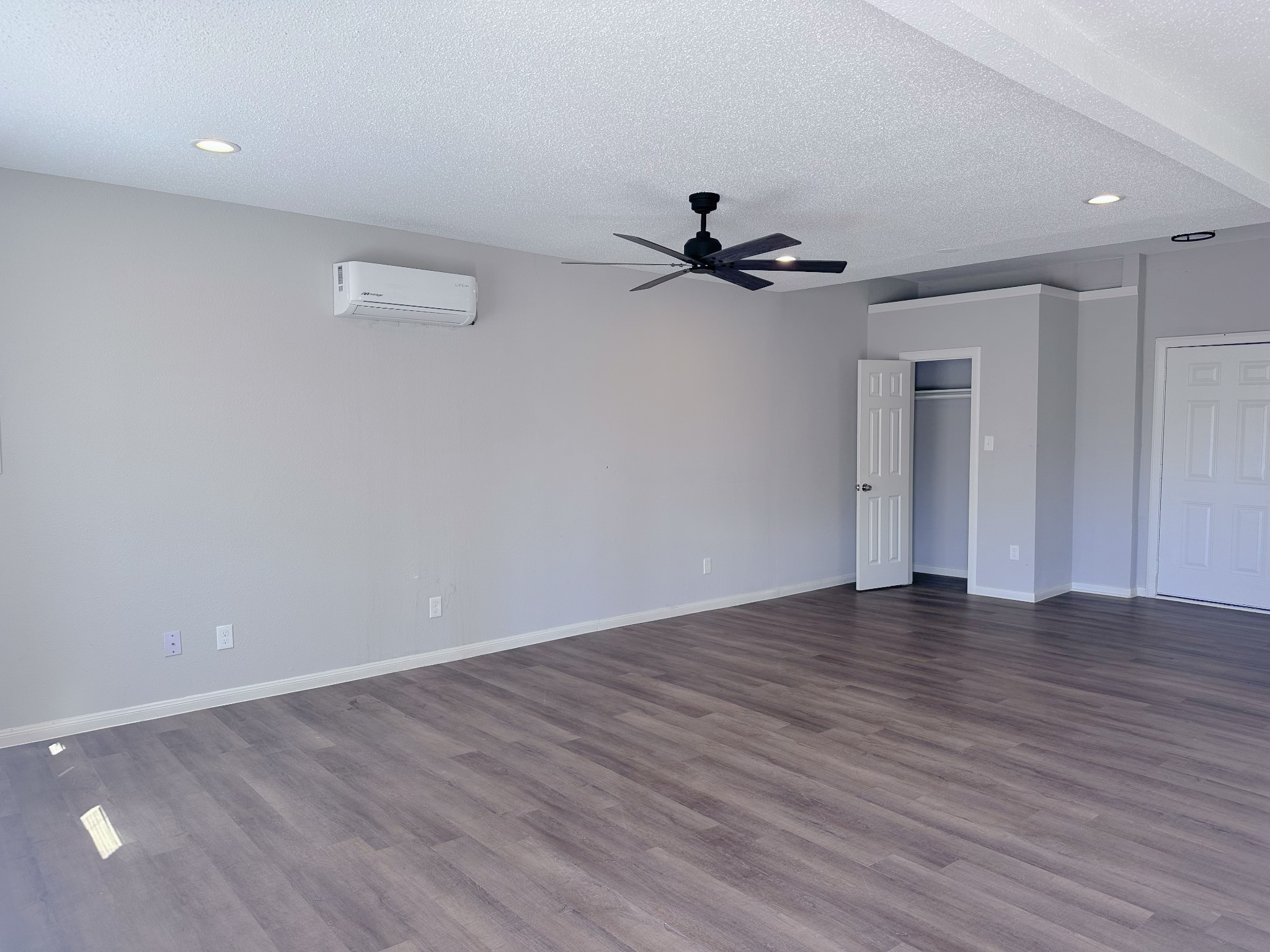 2704 Brewster Street Houston, TX 77026 - Photo 4 of 10 a view of an empty room with wooden floor and a ceiling fan