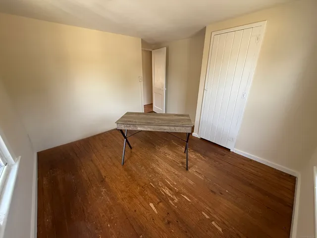 a room with wooden floor and a window