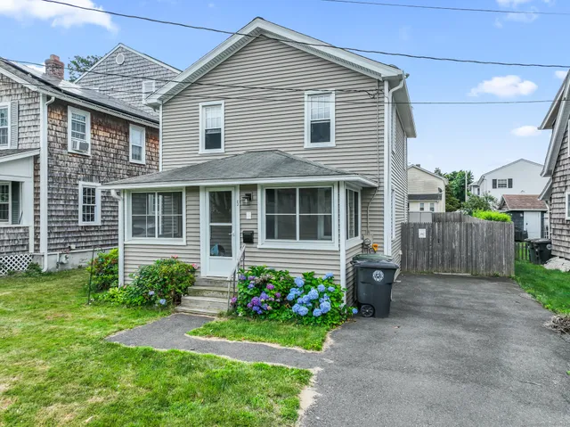 a front view of a house with a garden and porch