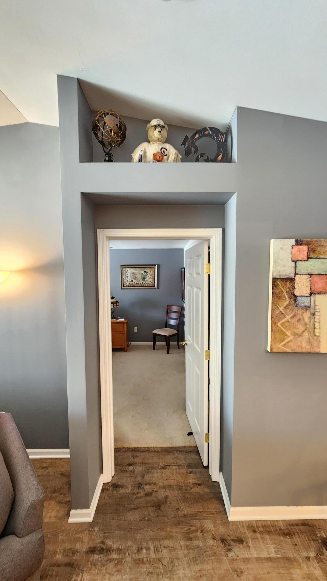 604 Cambridge Court, Unit 2A Munster, IN 46321 - Photo 13 of 31 a view of a hallway to a livingroom with wooden floor and furniture
