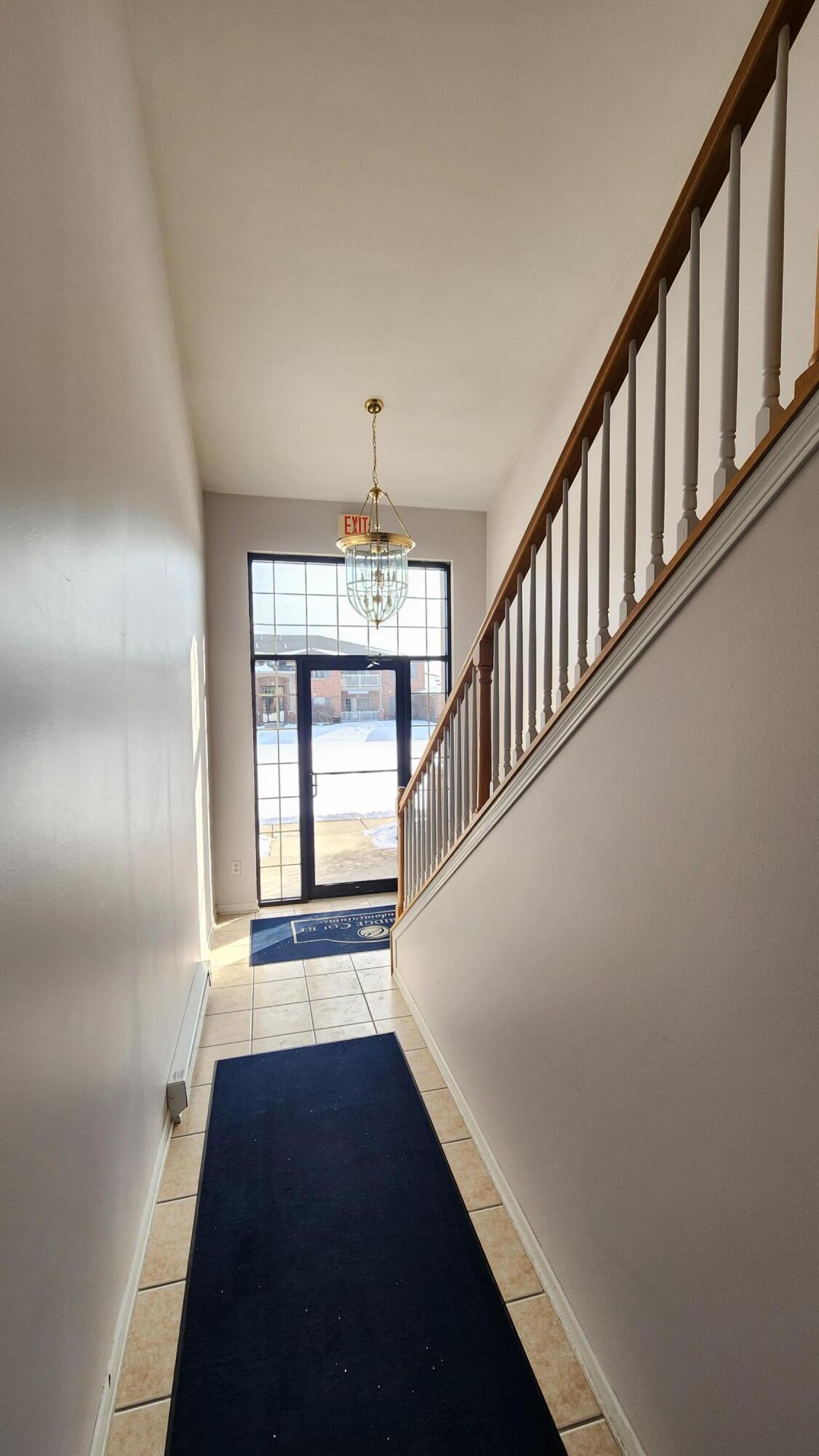 604 Cambridge Court, Unit 2A Munster, IN 46321 - Photo 2 of 31 a view of entryway and hall with wooden floor