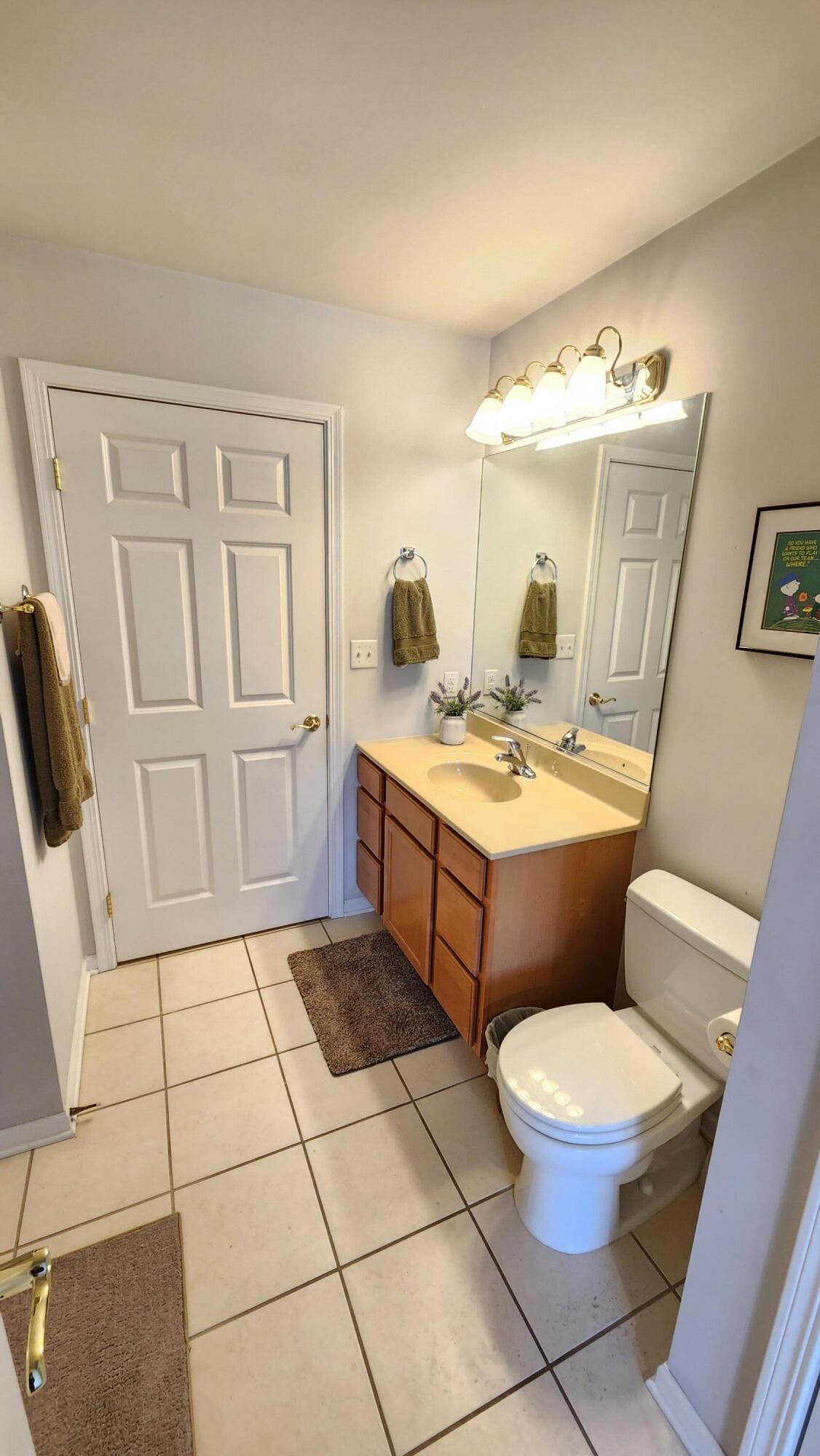 604 Cambridge Court, Unit 2A Munster, IN 46321 - Photo 21 of 31 a bathroom with a toilet a sink and a mirror
