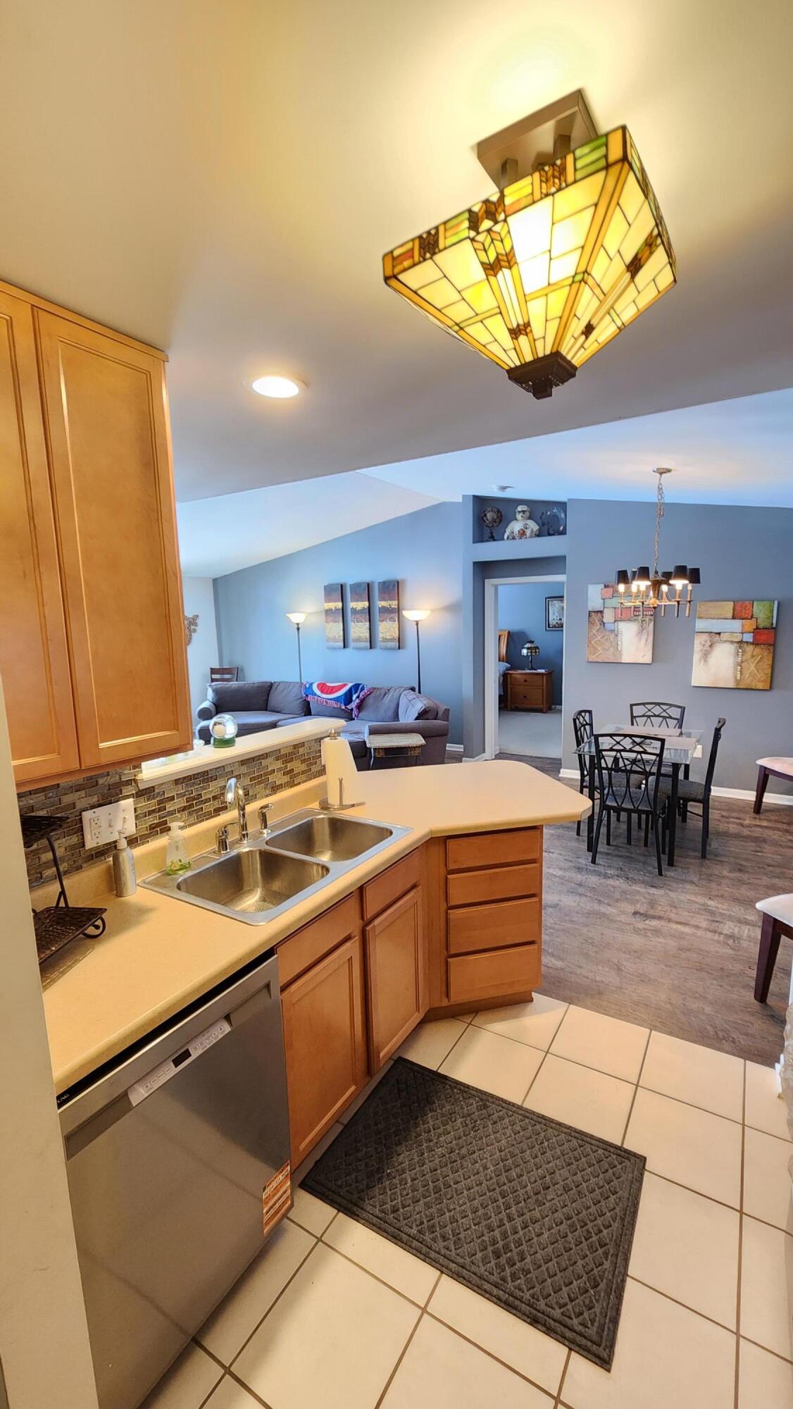 604 Cambridge Court, Unit 2A Munster, IN 46321 - Photo 7 of 31 a kitchen with stainless steel appliances granite countertop a sink and cabinets