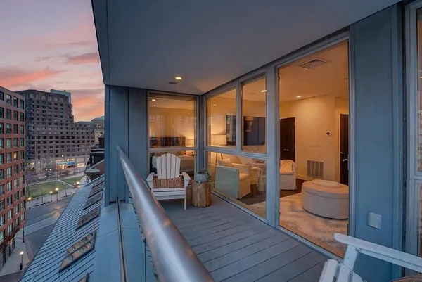 a view of a balcony dining table and chairs