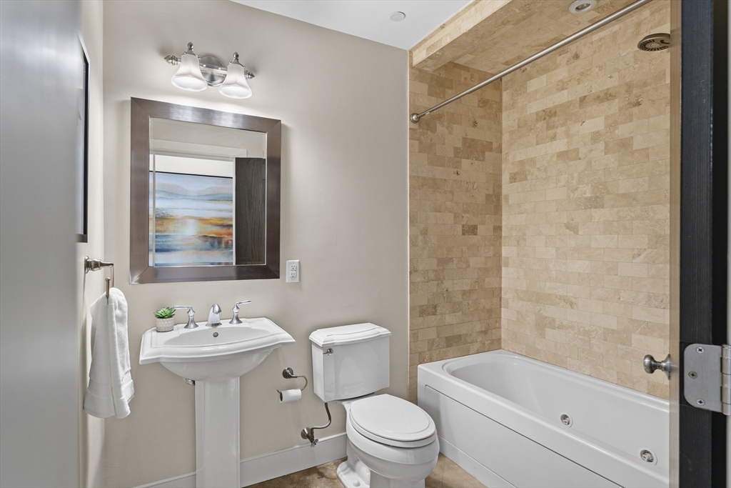 99-105 Broad Street, Unit 8B Boston, MA 02110 - Photo 15 of 37 a bathroom with a sink toilet and shower