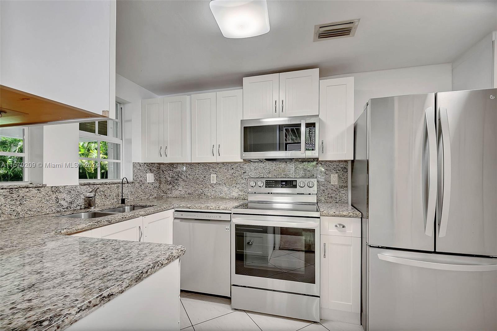 3620 Curtis Lane Miami, FL 33133 - Photo 27 of 33 a kitchen with a sink stove and refrigerator