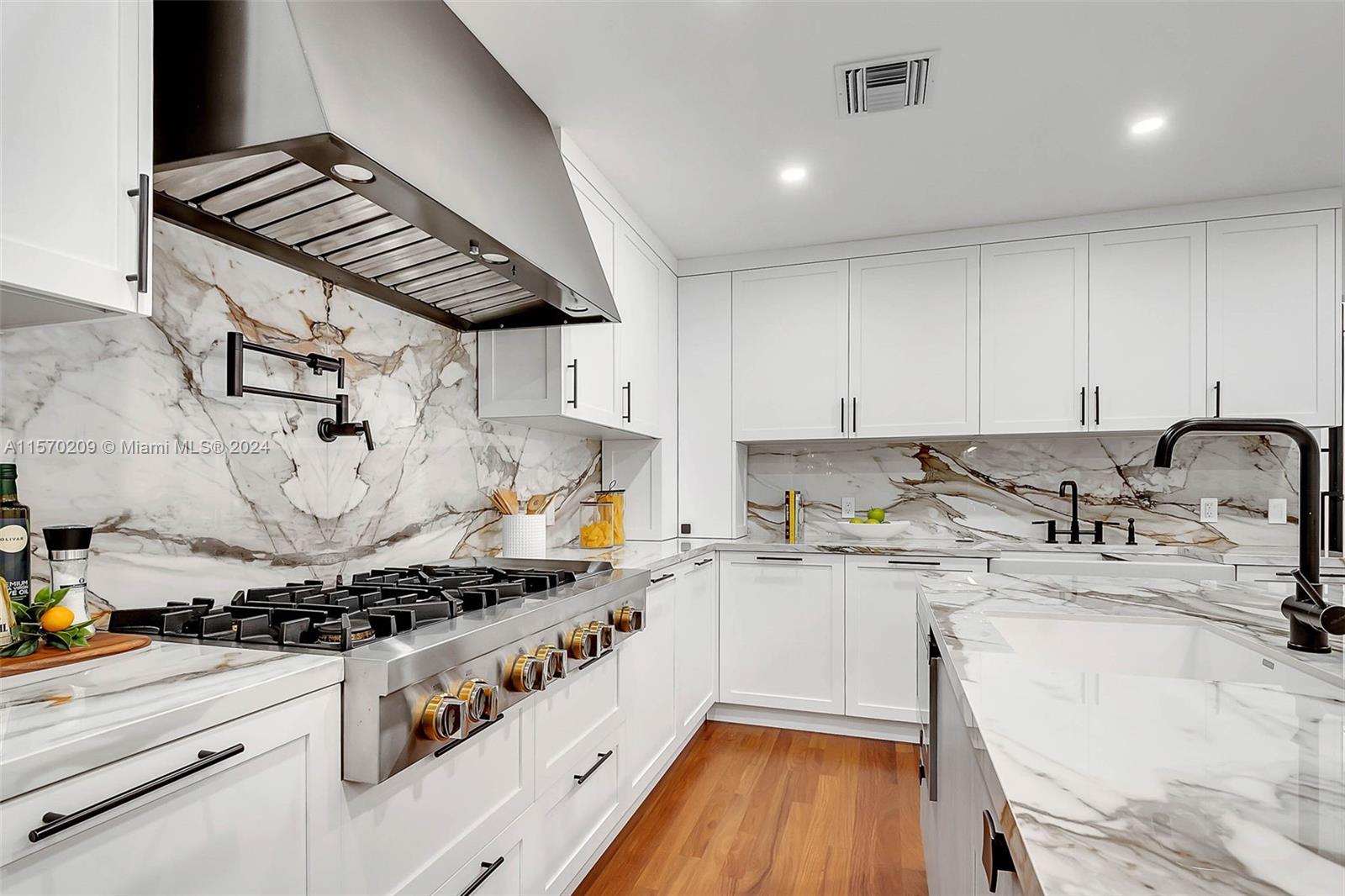 3620 Curtis Lane Miami, FL 33133 - Photo 7 of 33 a kitchen with a stove a sink and a refrigerator