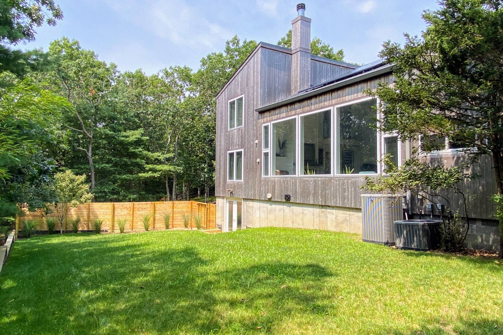 30 Wheelock Walk East Hampton, NY 11937 - Photo 14 of 15 a view of a house with a backyard and a small yard