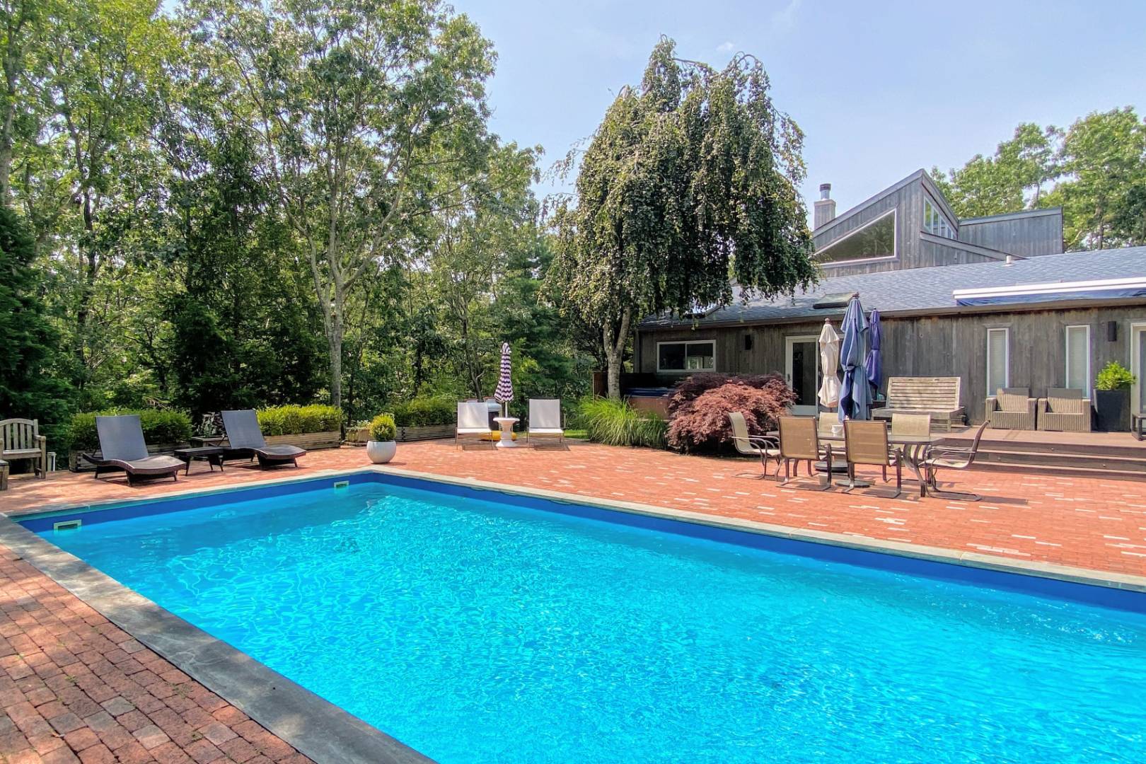 30 Wheelock Walk East Hampton, NY 11937 - Photo 9 of 15 a view of a swimming pool with lounge chairs in patio