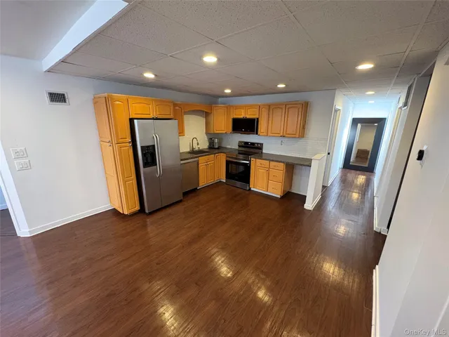 a view of living room with furniture and wooden floor