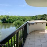 a view of a patio with wooden floor and lake view