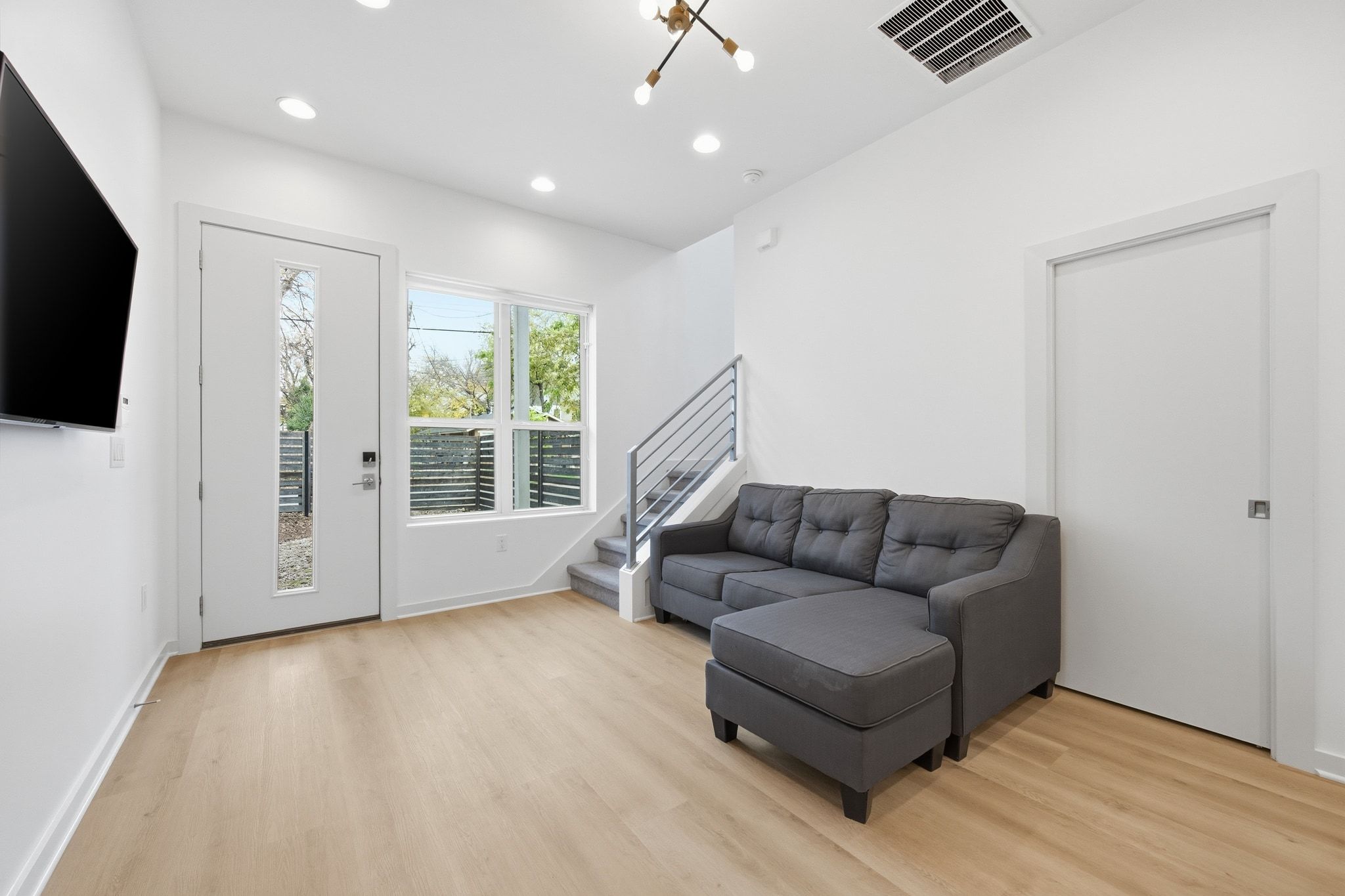 2811 Garwood Street, Unit A Austin, TX 78702 - Photo 11 of 27 a living room with furniture and a flat screen tv
