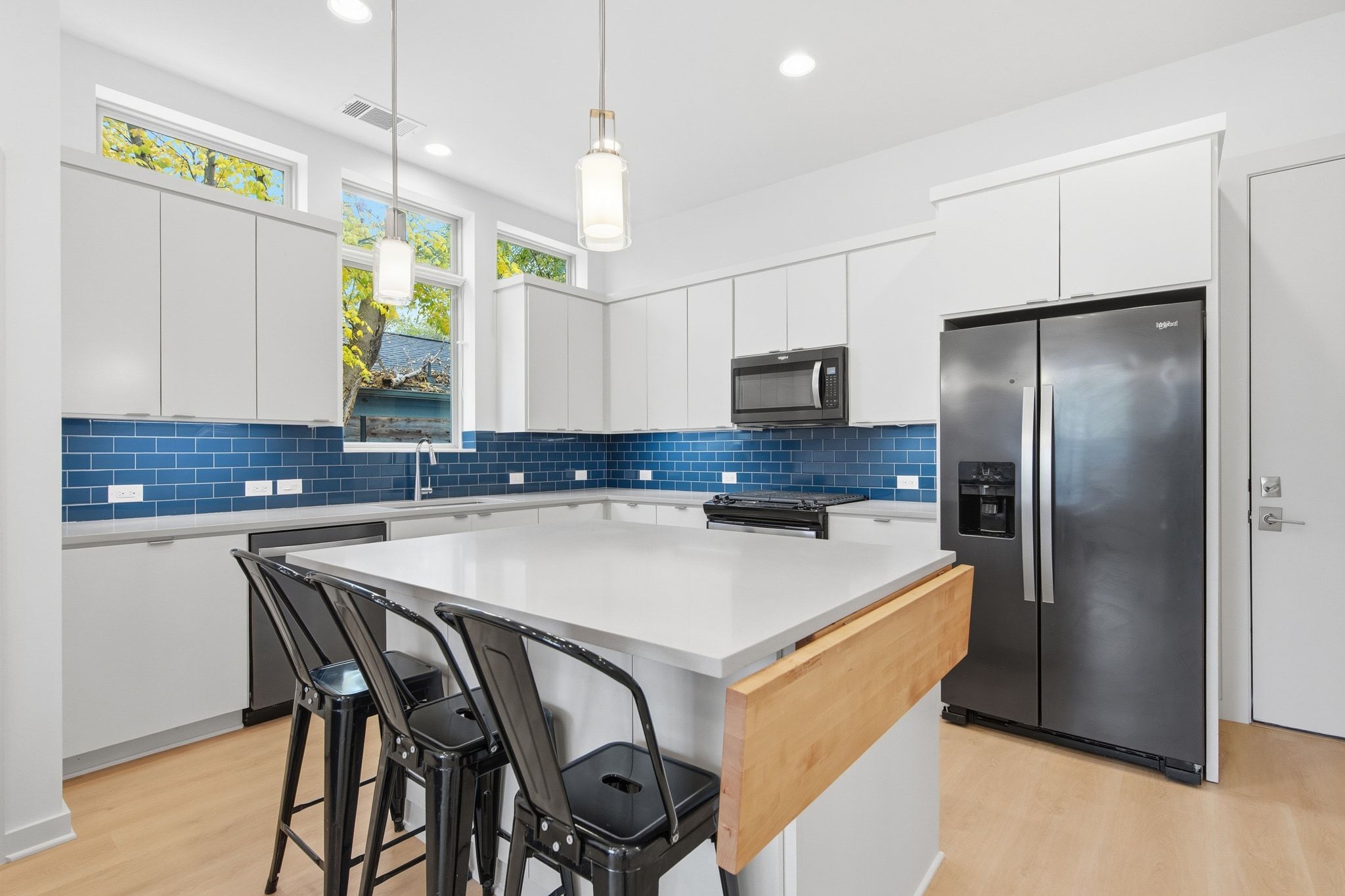 2811 Garwood Street, Unit A Austin, TX 78702 - Photo 13 of 27 a kitchen with stainless steel appliances granite countertop a refrigerator a sink a stove a dining table and chairs