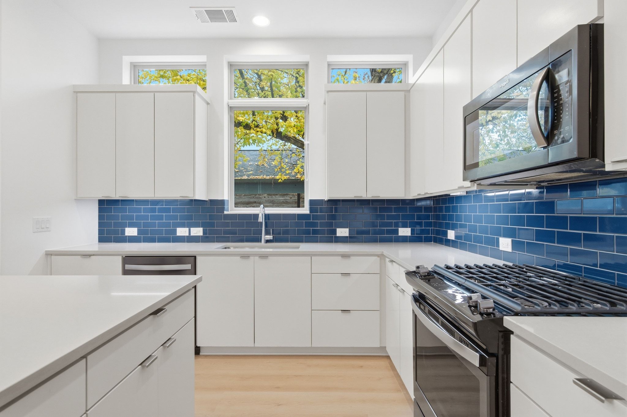 2811 Garwood Street, Unit A Austin, TX 78702 - Photo 17 of 27 a kitchen with stainless steel appliances granite countertop a stove a sink and a microwave