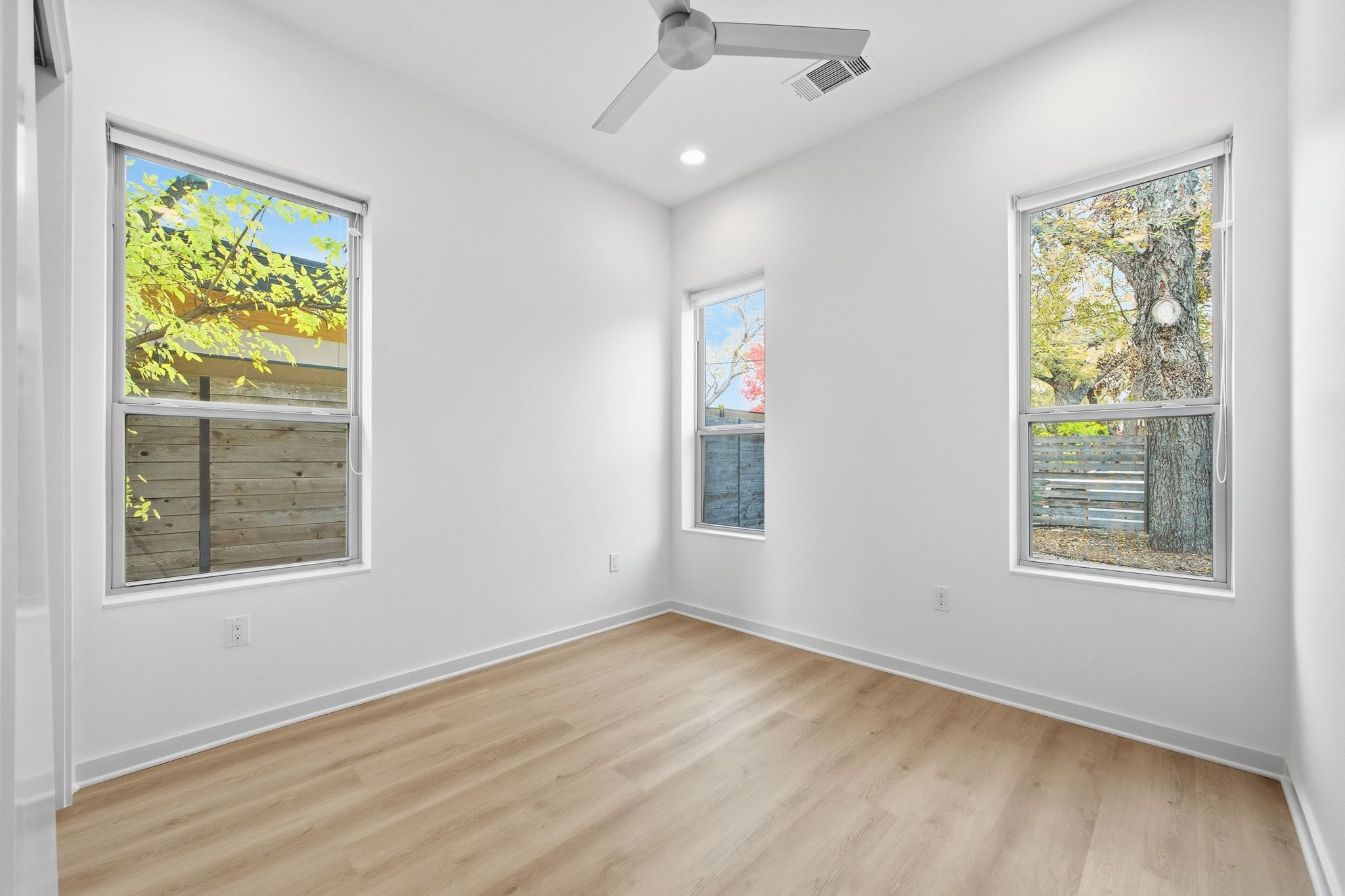 2811 Garwood Street, Unit A Austin, TX 78702 - Photo 18 of 27 an empty room with wooden floor and windows