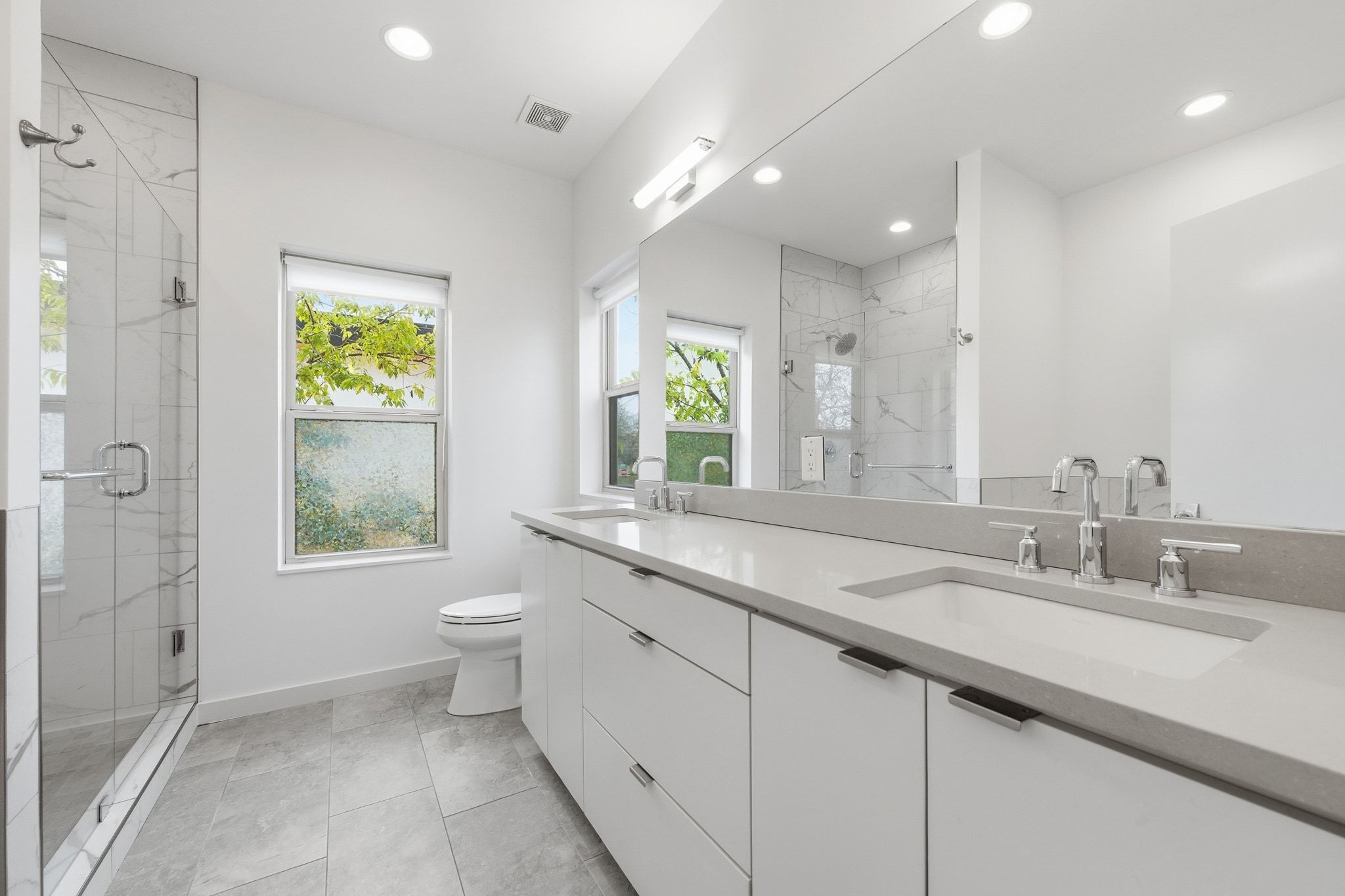 2811 Garwood Street, Unit A Austin, TX 78702 - Photo 22 of 27 a bathroom with a granite countertop sink mirror and a toilet