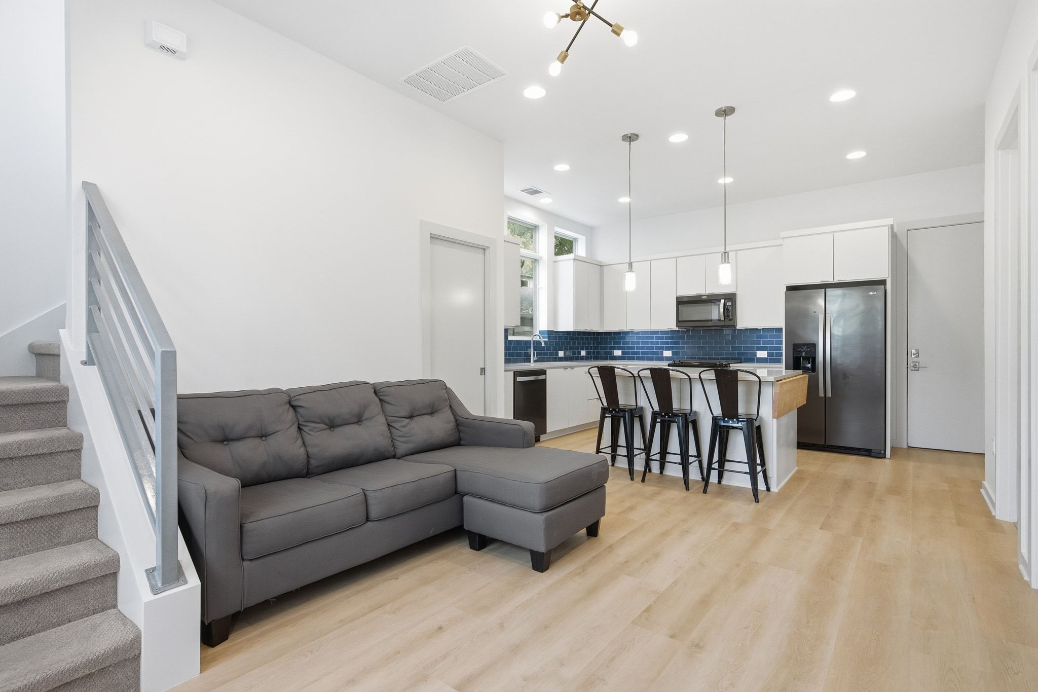2811 Garwood Street, Unit A Austin, TX 78702 - Photo 9 of 27 a living room kitchen with stainless steel appliances kitchen island granite countertop a dining table and chairs