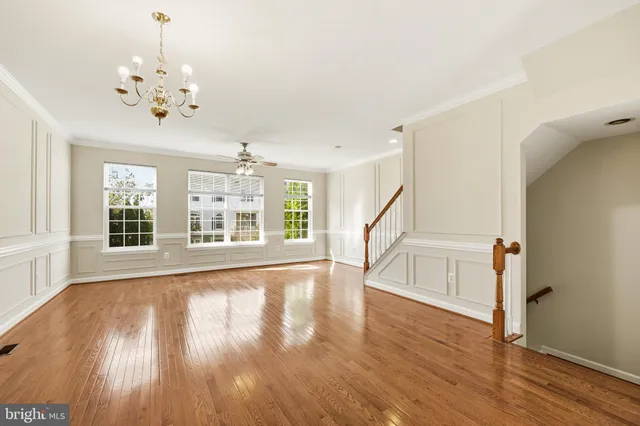 a view of an room with wooden floor and windows