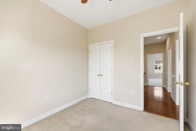 an empty room with wooden floor and mirror