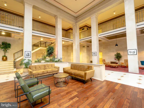 a living room filled with furniture windows and a table