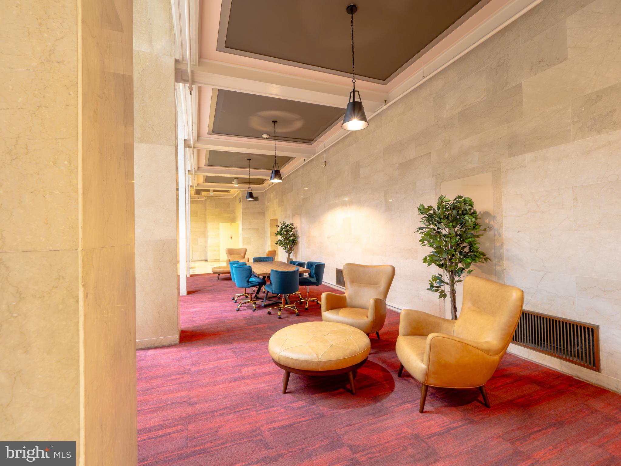 1601 Spring Garden Street, Unit 208 Philadelphia, PA 19130 - Photo 14 of 19 a living room with furniture a chandelier and a wooden floor
