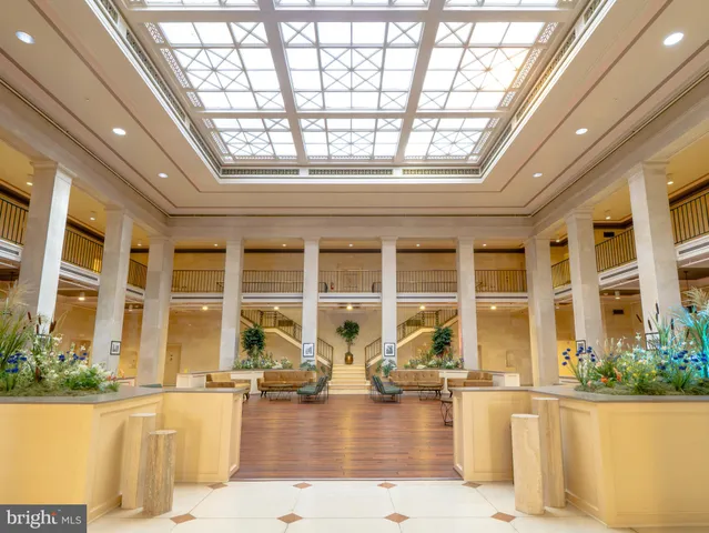a front view of a house with swimming pool and outdoor seating